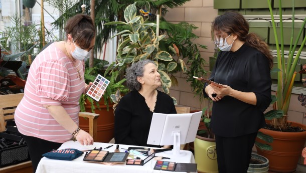 MossRehab occupational therapists assisting a patient with putting on makeup.