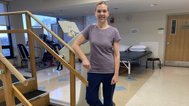 Gretchen standing in a physical therapy gym