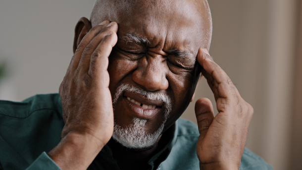 Man holding his head in pain