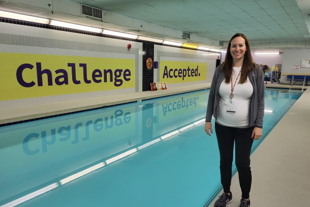 Amanda Gagnon stands next to a swimming pool.